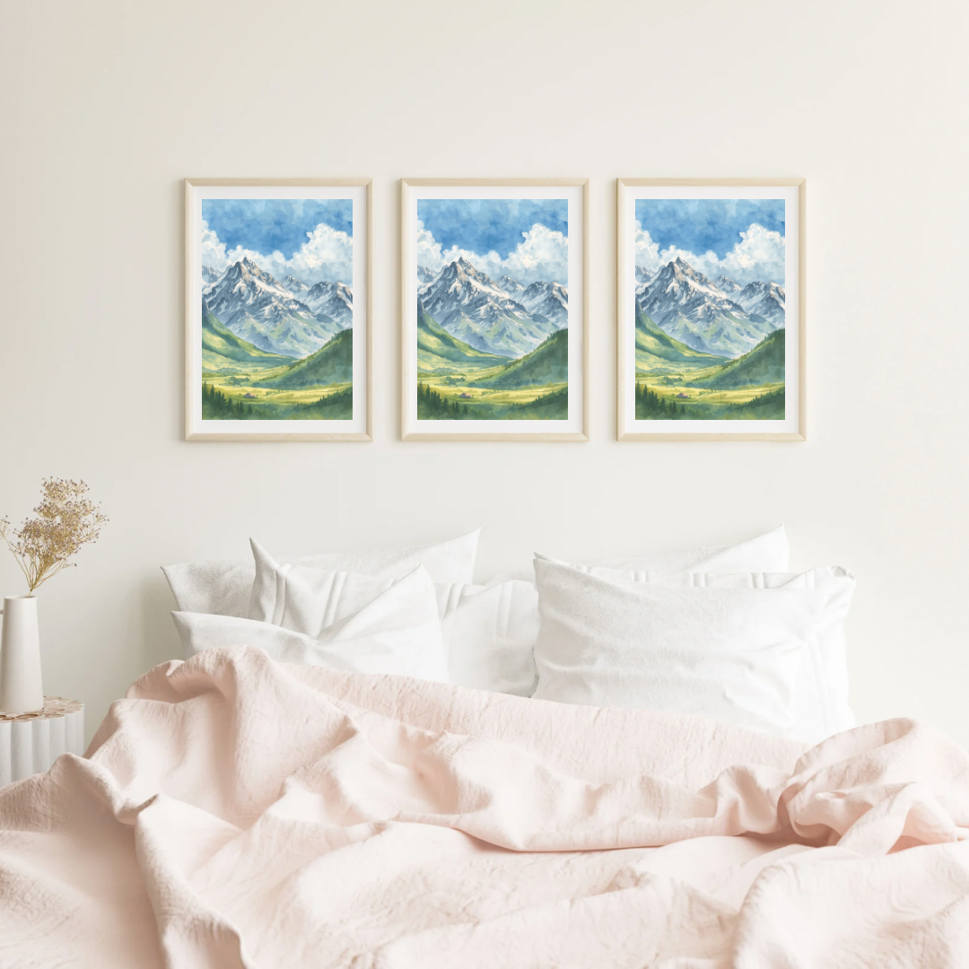 Alpen bergen schilderij als set van drie in witte lijst aan witte muur boven roze bed met witte kussens en zacht roze beddengoed – aquarel wall art slaapkamer