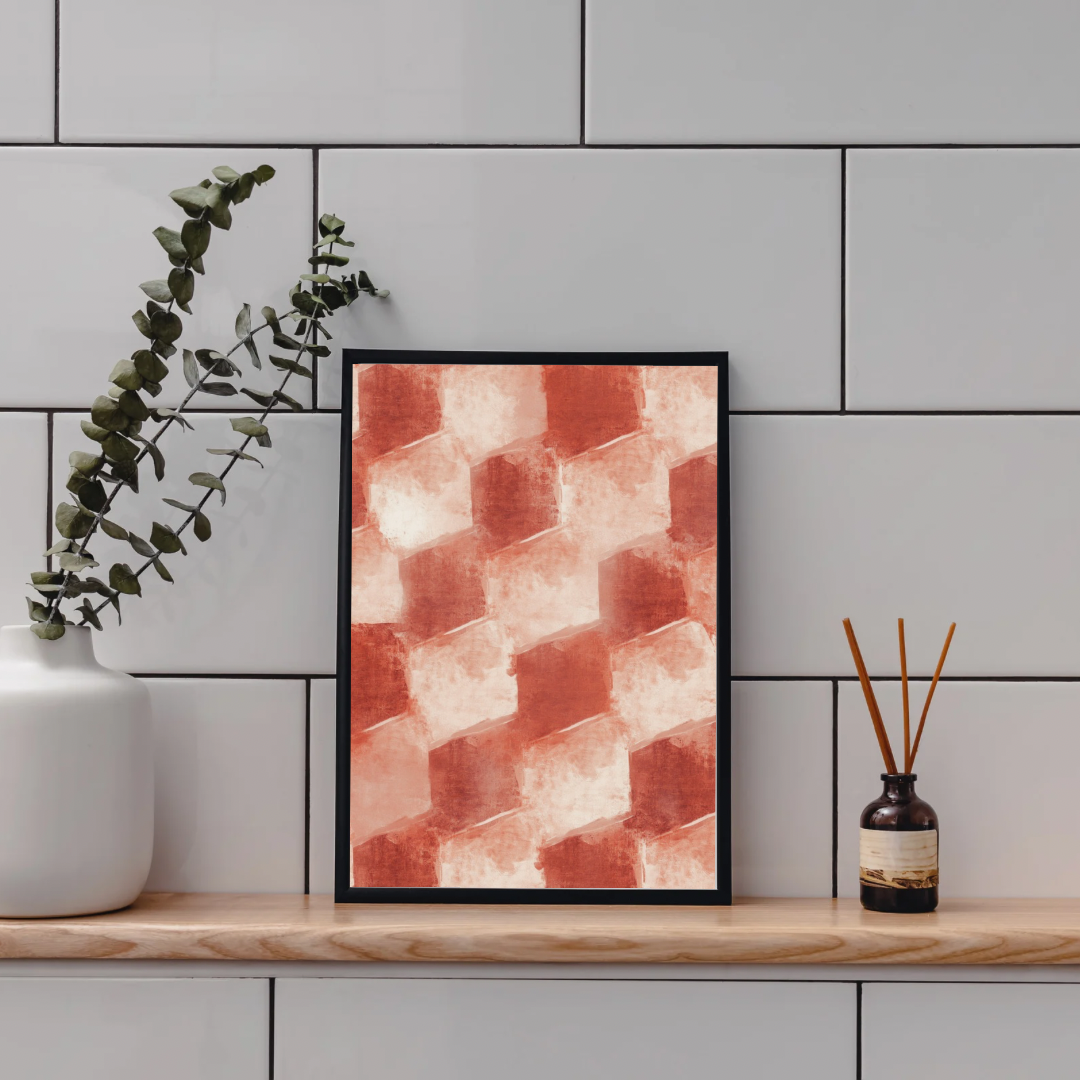 Geometrisch blokpatroon terracotta schilderij in zwarte lijst staand op houten plank aan grijze tegelmuur naast witte vaas met eucalyptus en bruine diffuser – abstract wall art toilet