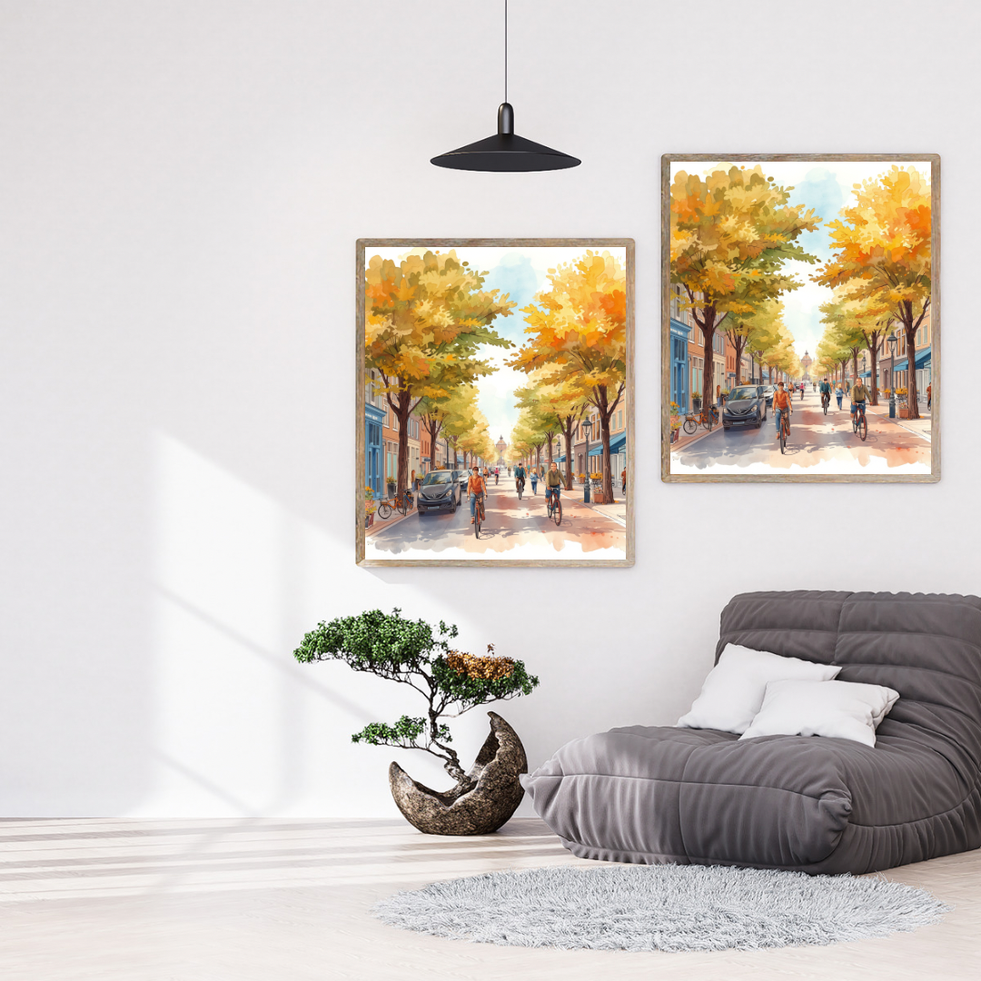 Deventer zonnige herfstlaan schilderij als set van twee in zwarte lijst aan witte muur boven grijze bank met groene plant en zwarte hanglamp – aquarel wall art woonkamer
