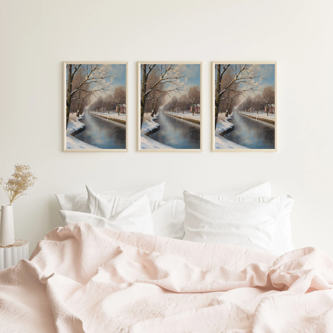 Dordrecht klassieke winter schilderije als set van drie in zwarte lijst aan witte muur boven wit bed met witte en beige kussens – olieverf wall art slaapkamer

