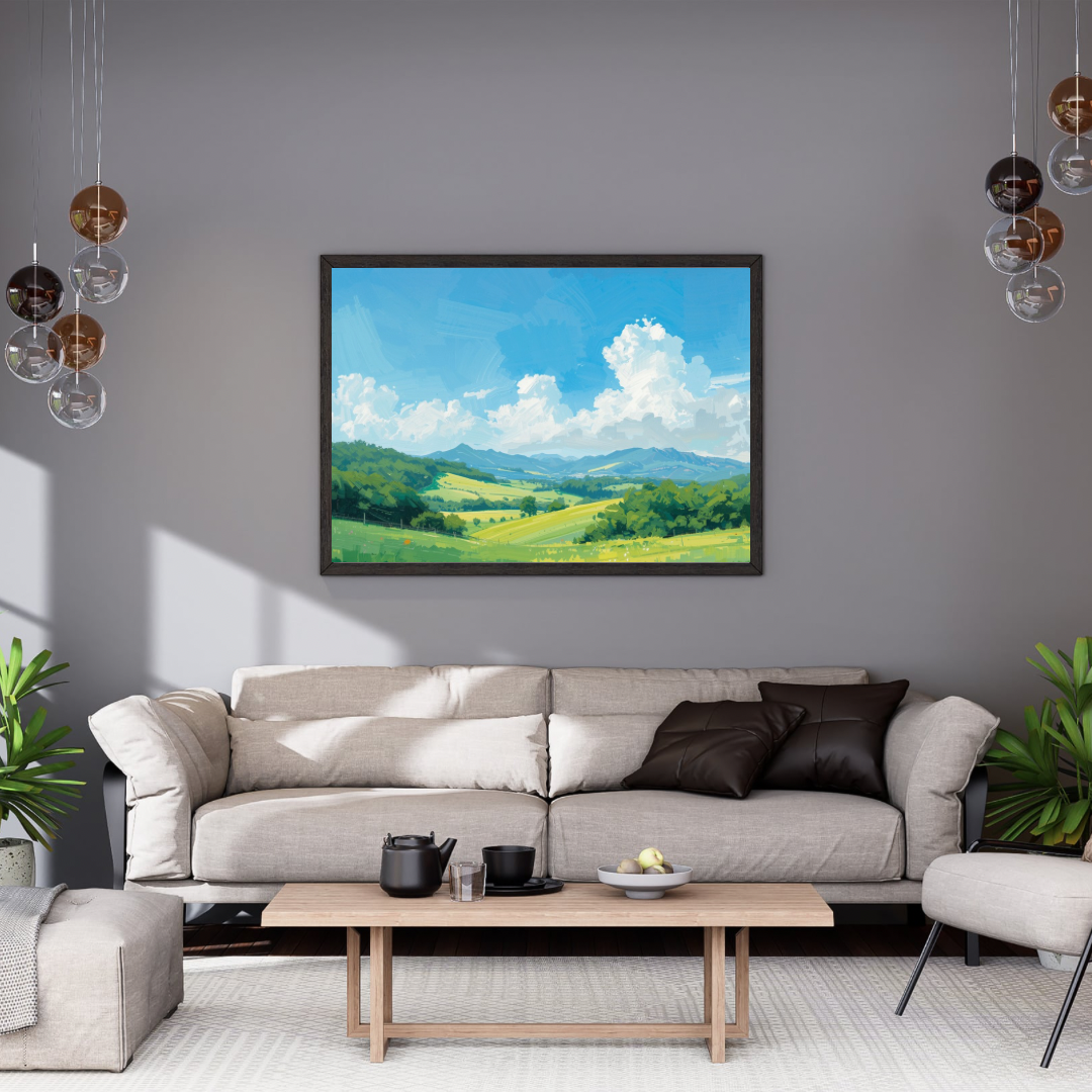 Zomer heuvellandschap schilderij in zwarte lijst aan grijze muur boven grijze bank met grijze kussens en ronde salontafel – olieverf wall art woonkamer
