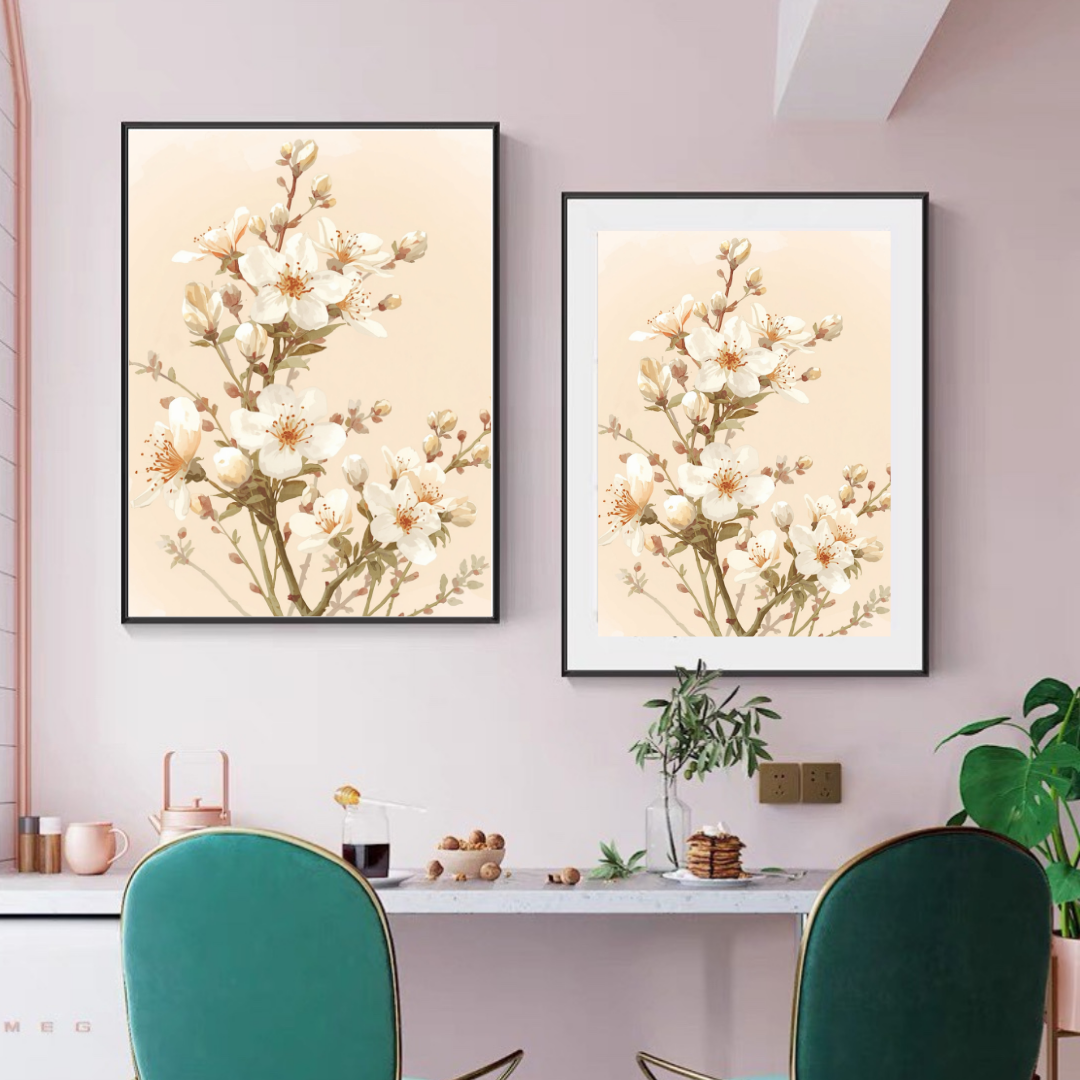 Witte bloesem schilderij als diptiek in zwarte lijsten aan roze muur boven wit bureau met groene plant en groene stoel in werkkamer – wall art print interieur

