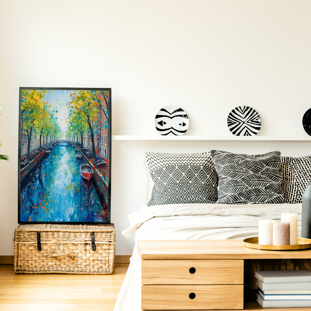 Amsterdam gracht herfst schilderij in houten lijst aan witte muur boven houten nachtkastje naast wit bed met grijze kussens in slaapkamer – wall art print
