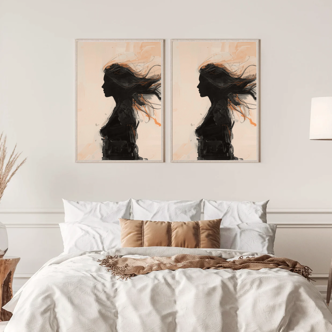Vrouw silhouet schilderij met zwart profiel en wapperende haren op beige in twee gouden lijsten naast elkaar aan witte muur boven bed met linnen beddengoed – vrouwelijk wall art slaapkamer
